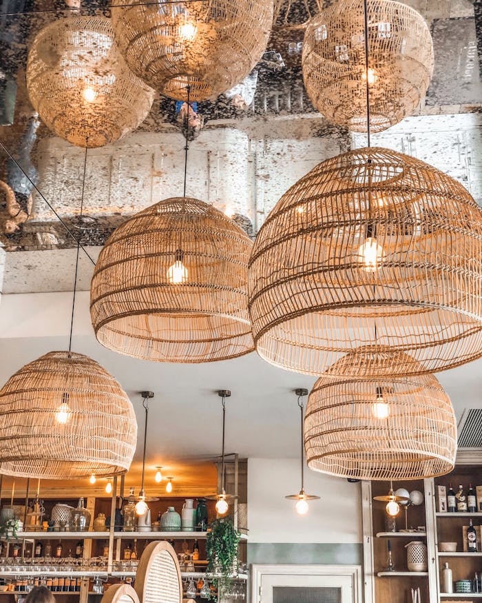 gallery-4 Stylish wicker pendant lights enhancing the ambiance of a modern French café in Alfortville, France.
